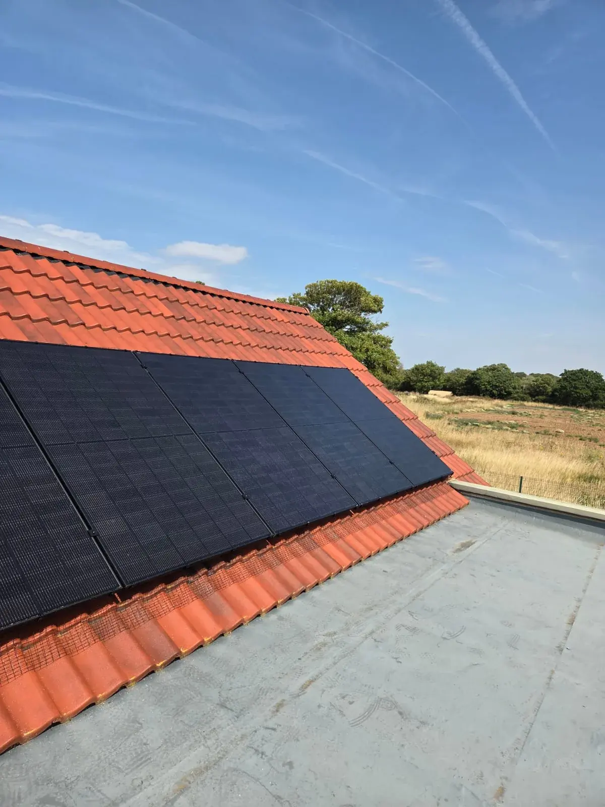 A modern UK housing development with solar panels installed on one roof